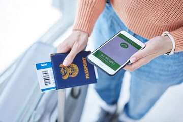 Phone, covid passport and qr code in the hands of a woman passenger in the airport for immigration,...
