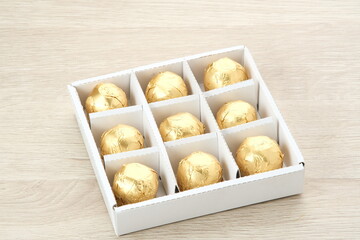 Chocolate candies with dates fruit filling in a box. Gifts festive food love concept.
