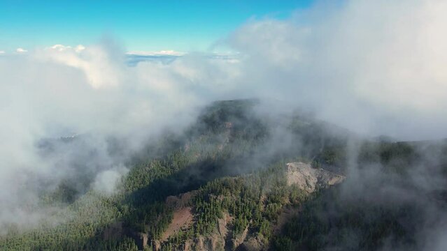 Aerial 4K footage of Teide National park and mount Teide in the distance above the white puffy sea of clouds. Volcano in Teide national park in Tenerife island, Spain.
