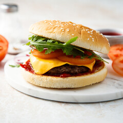 Traditional homemade cheeseburger with arugula