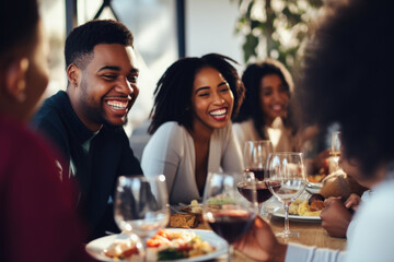 African American family having dinner during thanksgiving day. Happy people celebrating holiday, eating and laughing together