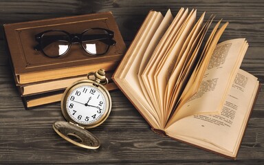 The retro vintage clock on an old book.