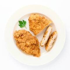 Fried chicken schnitzel portion with parsley sprig on white plate on isolated white background top view for your design. Healthy food. Protein, Vitamins, healthy fats for human health. Bio products