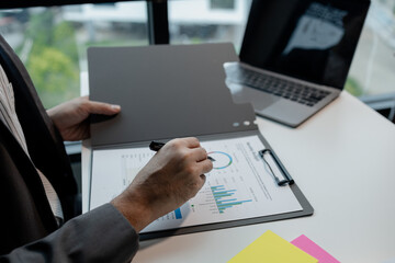 Working on laptop and looking at documents, Editing documents to send to customers, Review the documents for opening a startup company, Plan documents for attending the meeting.