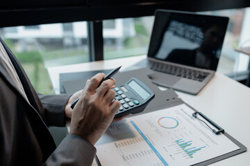 Calculating the currency for account transfer, Currently analyzing investment possibilities, The accountant is checking the financial liquidity of the company, finance idea.