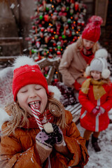 Happy girl on red outfit with candy on christmas new year's eve