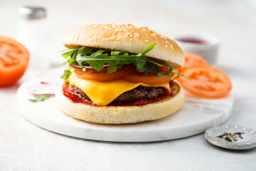 Traditional homemade cheeseburger with arugula