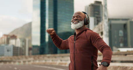 Fitness, celebration and senior man, headphones, city and achievement with workout, streaming music and radio. African person, pensioner and runner with headset, progress and exercise wellness or joy