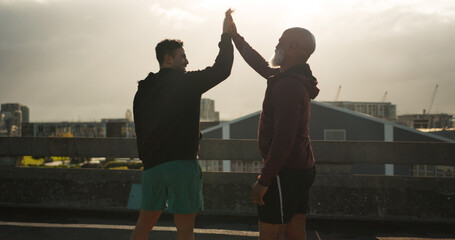 Man, high five and fitness in city for workout, training or success in outdoor exercise together....