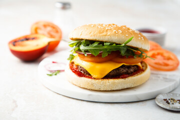 Traditional homemade cheeseburger with arugula