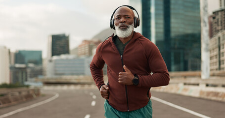 Mature, person and running in city with headphones for fitness, workout and marathon training music. Black man, athlete or exercise podcast in South Africa for cardio wellness, health or sports radio