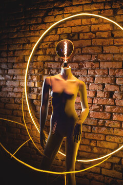 Floor lamp woman mannequin in the yellow neon light circle background.