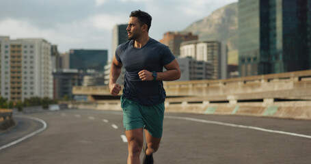 Runner, road or man for fitness in training, sport or exercise goals for marathon competition. Indian athlete, wellness or running challenge in cape town race in progress, city street or health body