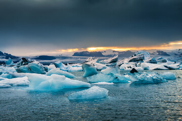  Jokulsarlon glacier lagoon with blue iceberg melting during summer in the evening at Vatnajokull national park, Iceland