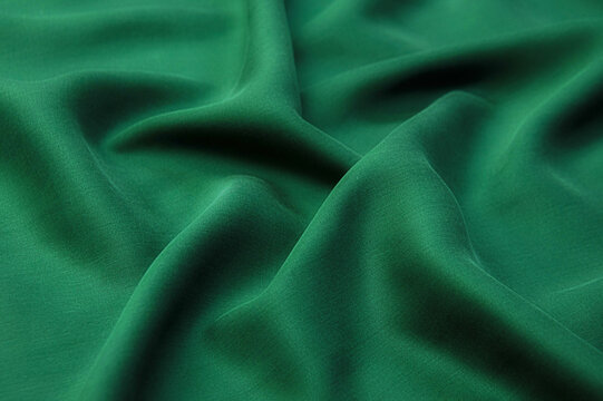 Abstract background texture of natural green color fabric. Fabric texture of natural cotton or linen, silk or satin, wool or jersey textile material. Luxurious canvas background..