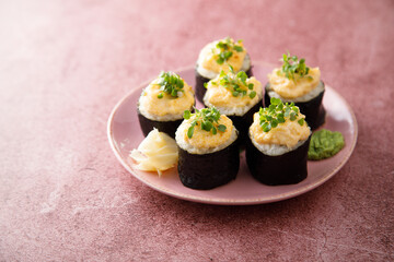Homemade sushi rolls with roe topping