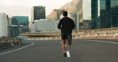Man, back and running in morning on city, street and bridge for fitness, workout and marathon...