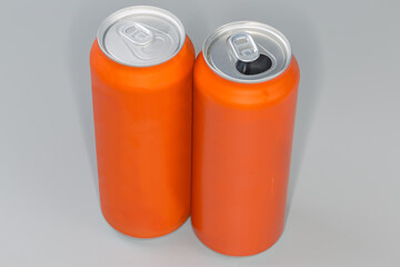 Sealed and open beverage cans orange color on gray background