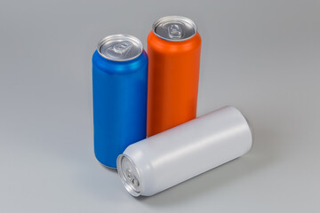 Sealed beverage cans of various colors on a gray background