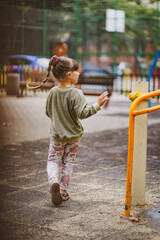 little child is playing on playground in varna bulgaria  - obrazy, fototapety, plakaty