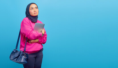 Photo of sad asian woman wearing jacket carrying laptop looking