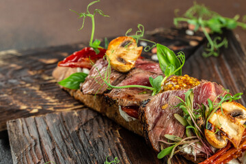 Homemade Steak sandwich with sliced roast beef on a wooden board. banner, menu, recipe copy space, top view