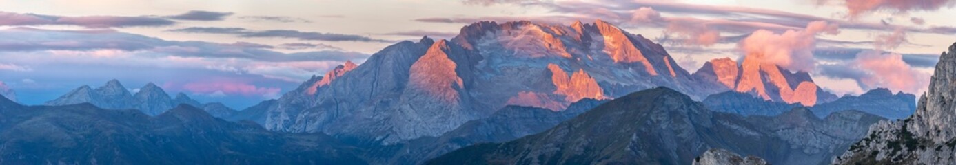 View of pink mountain peaks at sunrise from Falzarego pass, South Tyrol, Dolomites, Italy