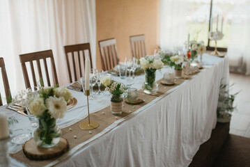 Flower decoration for celebrations. Decoration of tables and chairs. Rustic decoration.

