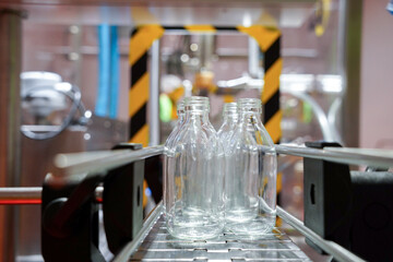 bottling process with an industrial production machine. automated conveyor to empty bottle production.