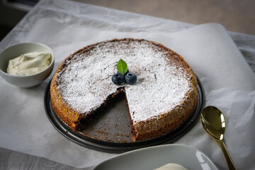 Traditional Swedish dessert called Kladdkaka. A stick chocolate cake with powder sugar.
