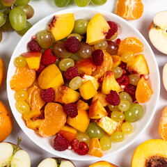 Fruit salad with sliced fruit, mixed grapes, raspberries, nectarines, tangerines and apples