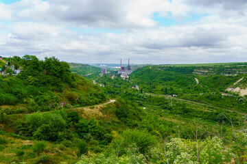 Plant or factory. Industrial area in a picturesque beautiful green area. Background with selective focus and copy space