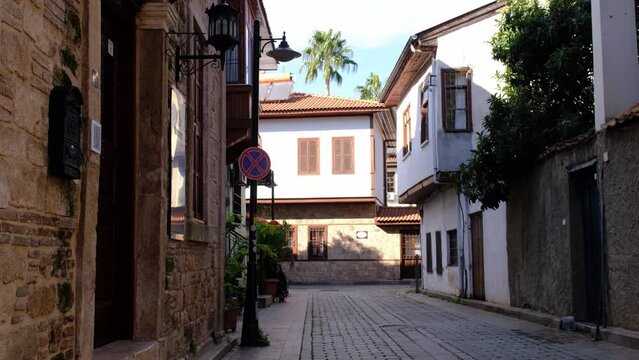 Antalya, Turkey December 25, 2021: Ottoman houses on pedestrian street in old town of Kaleici district, walk through the old city in Antalya. winter season