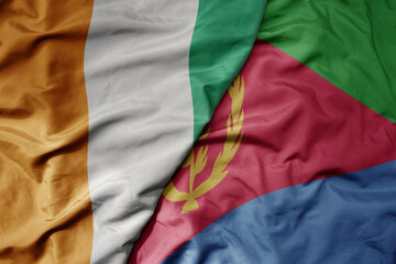 big waving national colorful flag of cote divoire and national flag of eritrea .