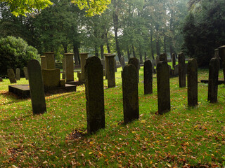Naklejka premium Silhouette of graves at a cemetery in the village Flinsterwolde, Groningen, the Netherlands