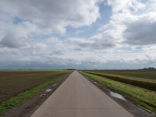 Road through cropland fields in Groningen, the Netherlands