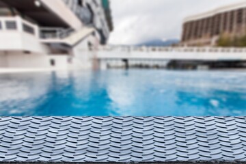 Empty blank table top on swimming pool background