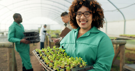 Woman, tray of plants and portrait in greenhouse for agriculture, eco friendly gardening and sustainable farming. Farmer or people with green sprout, vegetables growth and happy for agro development - Powered by Adobe