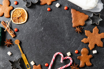 christmas, food cooking and winter holidays concept - close up of gingerbread cookies, molds,...