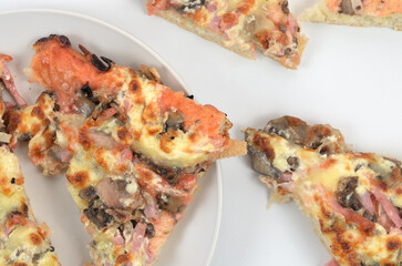 homemade juicy pizza on thick dough with lots of toppings photo on a white background
