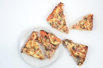 homemade juicy pizza on thick dough with lots of toppings photo on a white background