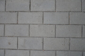 Close shot of running bond brick like gray concrete pavement