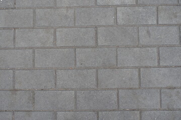 Surface of running bond brick like gray concrete pavement