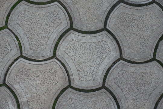 Macro of rounded gray concrete interlocking paver blocks