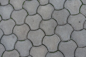 Texture of rounded gray concrete interlocking paver blocks
