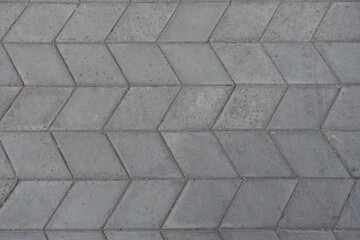 Texture of gray diamond shaped concrete pavement with geometric pattern
