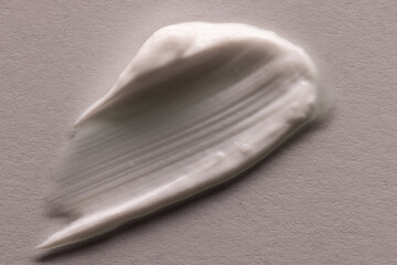 Close up of beauty product white cream smudge with copy space on white background
