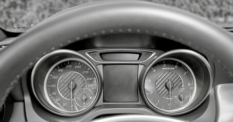 Sport car speedometer and sensors on a control panel background, modern car elements close view, driving a car photo
