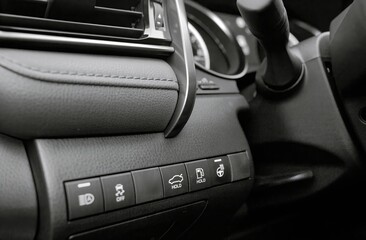 Car buttons on a control panel background, car elements close view