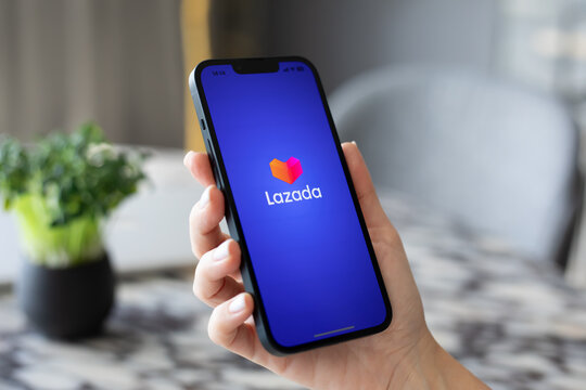 Woman hands holding iPhone 14 online Internet shopping service Lazada